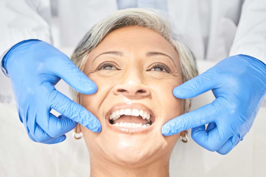 senior-woman-mouth-and-dentist-hands-with-dental-2023-11-27-05-22-28-utc