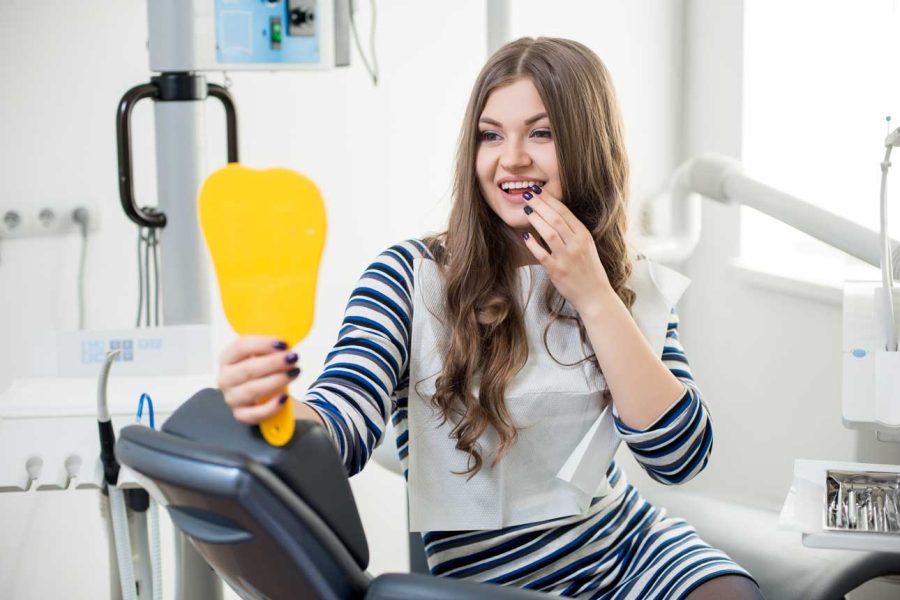 young-female-patient-with-perfect-white-teeth-sitt-2023-11-27-05-07-52-utc